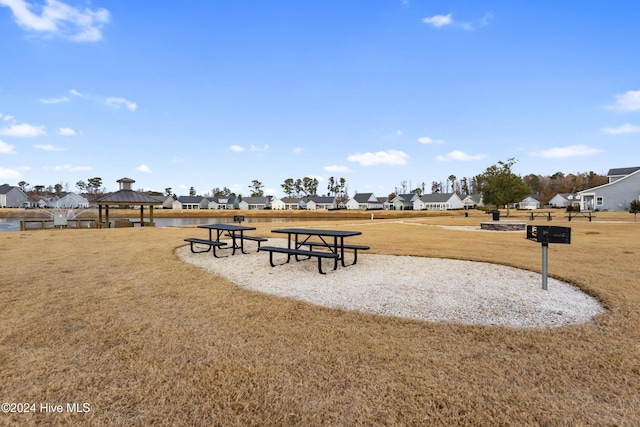 surrounding community with a gazebo and a yard