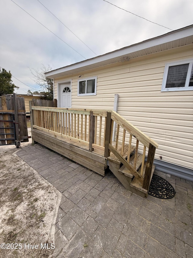 wooden deck with a patio area and fence