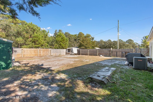 view of yard with cooling unit and a fenced backyard