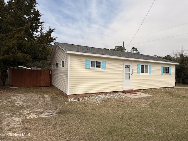 view of front facade featuring crawl space, roof with shingles, and fence