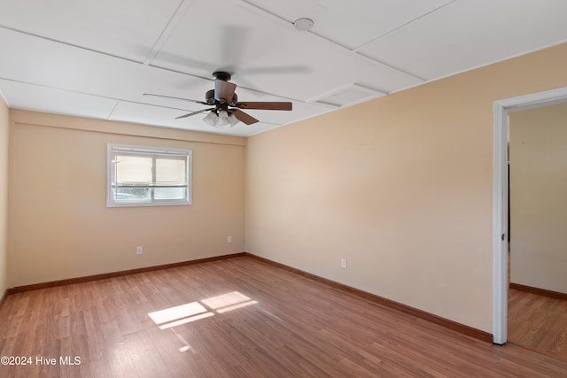 unfurnished room with baseboards, light wood-type flooring, and ceiling fan