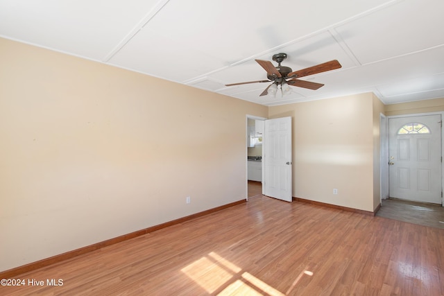 unfurnished room featuring ceiling fan, baseboards, and light wood-style flooring