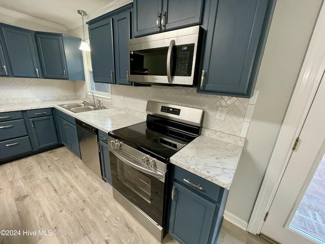 kitchen featuring sink, light hardwood / wood-style flooring, ornamental molding, decorative light fixtures, and stainless steel appliances