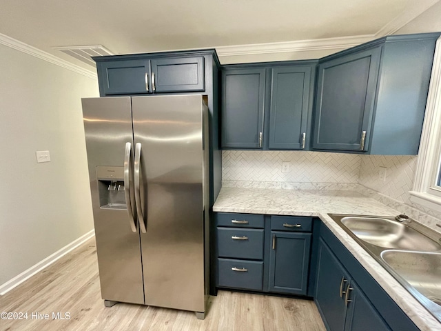 kitchen featuring stainless steel fridge, light hardwood / wood-style floors, sink, and blue cabinets