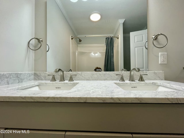 bathroom with vanity, curtained shower, and ornamental molding