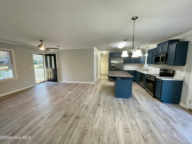 kitchen featuring a center island, stainless steel appliances, light hardwood / wood-style flooring, and ornamental molding