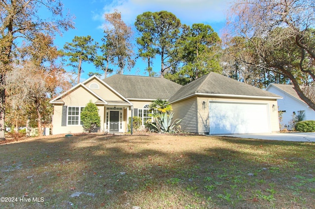 view of front of home with a garage and a front lawn