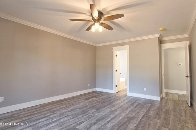 spare room with hardwood / wood-style flooring, ceiling fan, and ornamental molding