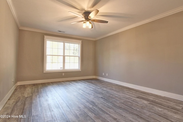 spare room featuring hardwood / wood-style floors, ceiling fan, and ornamental molding