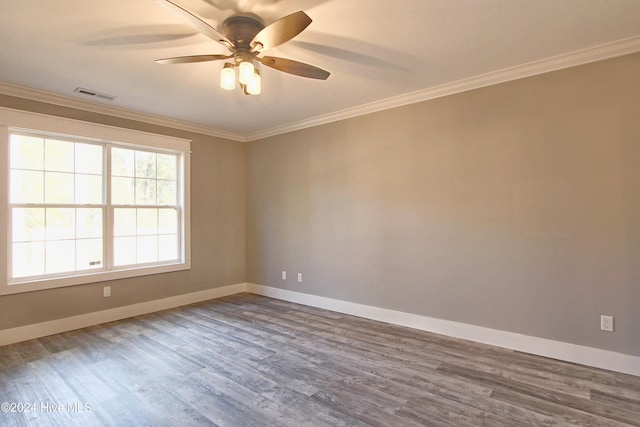 empty room featuring hardwood / wood-style floors, ceiling fan, and ornamental molding