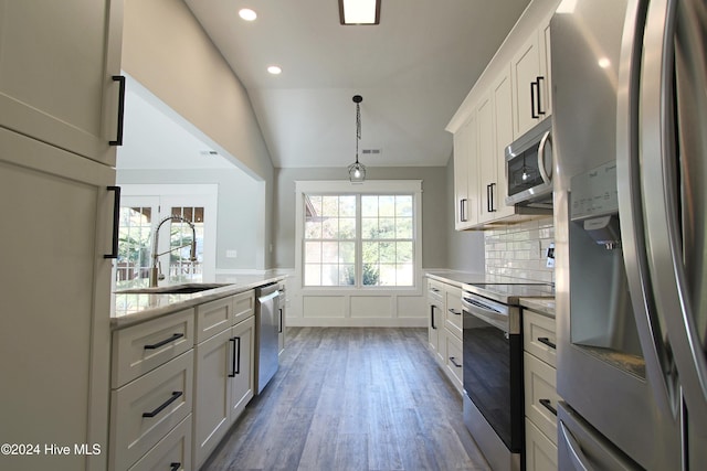 kitchen featuring appliances with stainless steel finishes, dark wood-type flooring, sink, white cabinets, and lofted ceiling