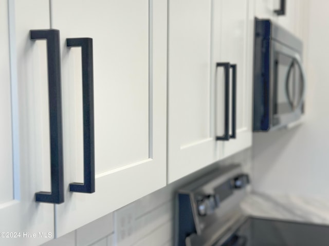 room details featuring appliances with stainless steel finishes and white cabinetry