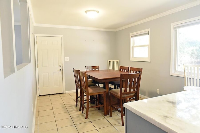 dining area featuring light tile patterned floors and crown molding