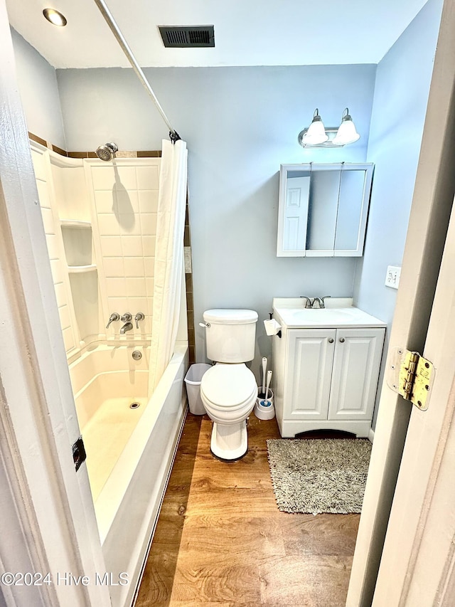 full bathroom with hardwood / wood-style floors, vanity, toilet, and shower / tub combo