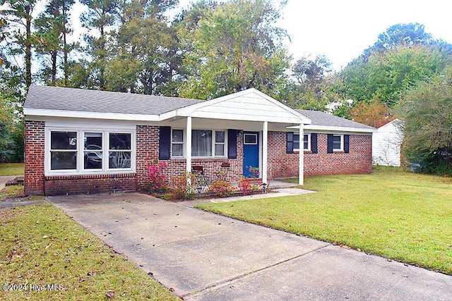 single story home with a front yard and covered porch