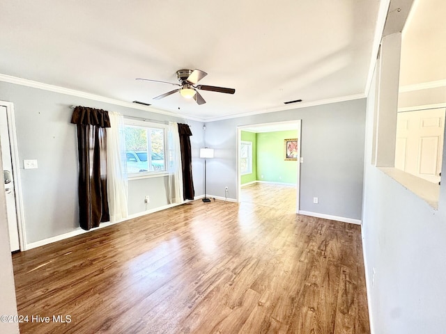 unfurnished room with hardwood / wood-style floors, ceiling fan, and ornamental molding