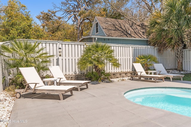 view of swimming pool featuring a patio, a fenced in pool, and fence