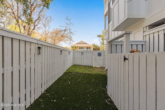view of yard featuring fence and a gate