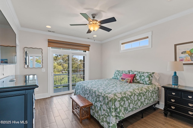 bedroom featuring dark wood-type flooring, ornamental molding, access to exterior, and multiple windows