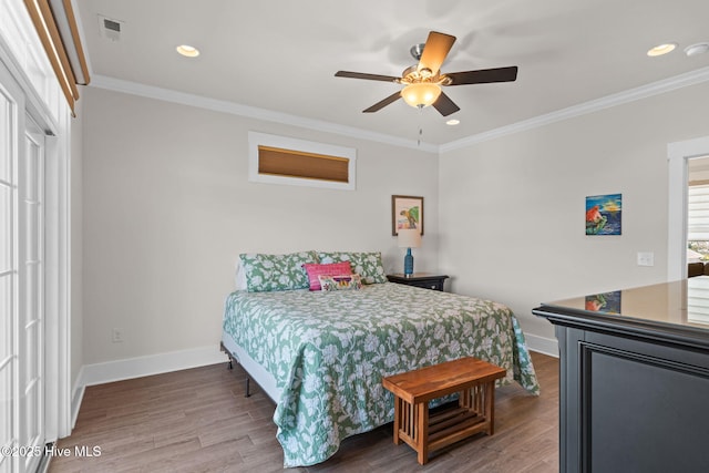 bedroom featuring ornamental molding, recessed lighting, wood finished floors, and baseboards