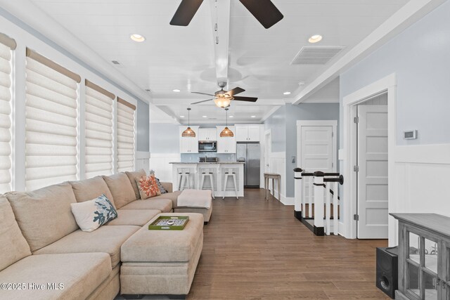living area featuring visible vents, a ceiling fan, wainscoting, and recessed lighting