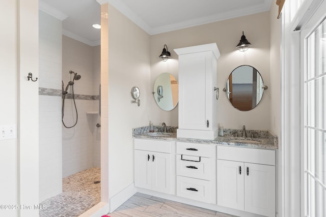 bathroom with walk in shower, double vanity, a sink, and ornamental molding