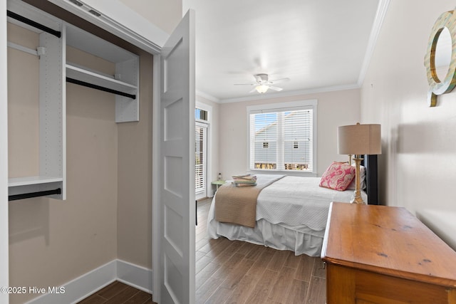 bedroom featuring ornamental molding, dark wood-style floors, a ceiling fan, and baseboards