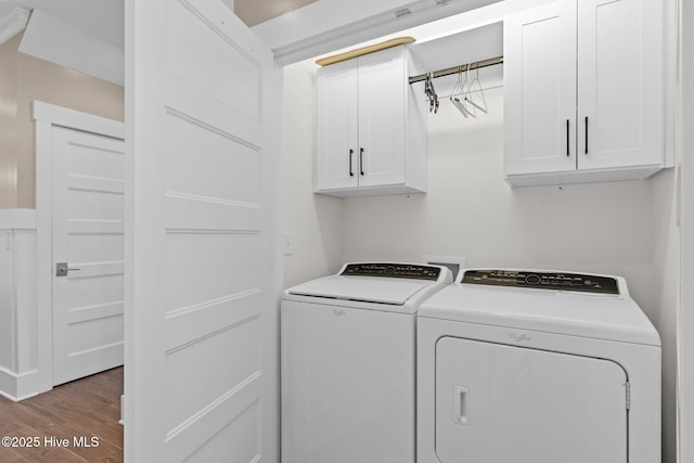 laundry area with separate washer and dryer, cabinet space, and wood finished floors