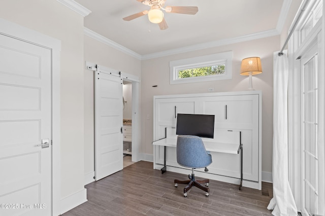 office featuring crown molding, wood finished floors, a barn door, and baseboards