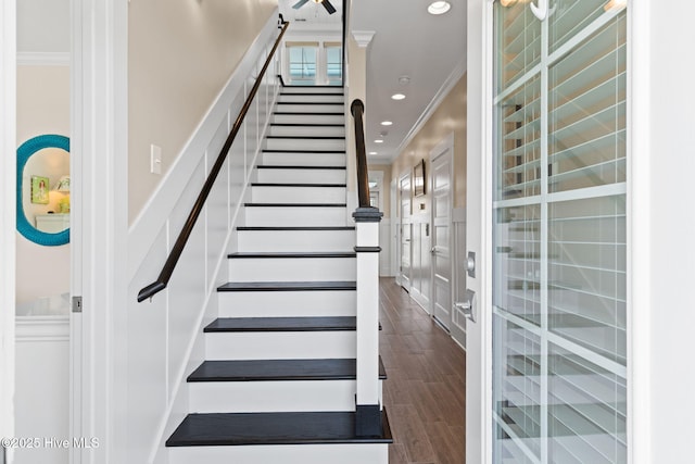 stairs featuring recessed lighting, ornamental molding, and wood finished floors