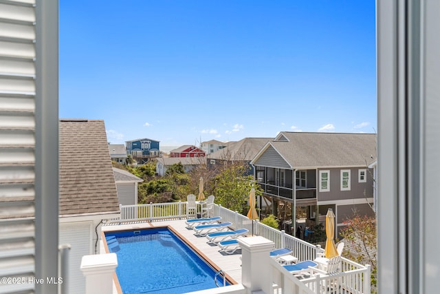 view of pool with a residential view, a fenced in pool, and fence