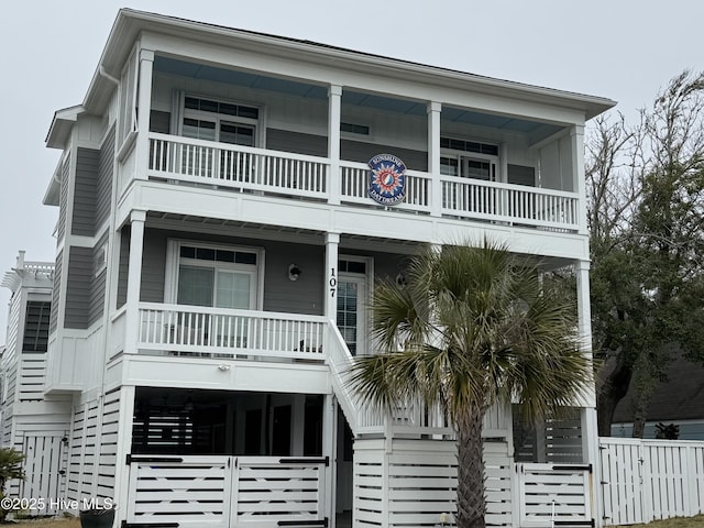 coastal home with a porch and a balcony