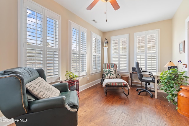 office with hardwood / wood-style flooring and ceiling fan