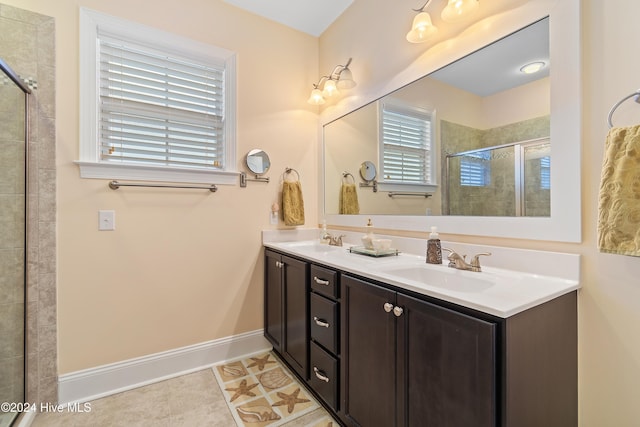 bathroom featuring tile patterned flooring, vanity, and a shower with door