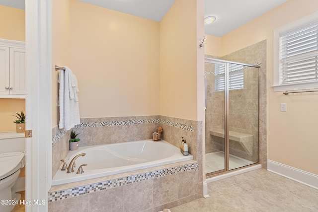 bathroom with plus walk in shower, tile patterned flooring, toilet, and a healthy amount of sunlight