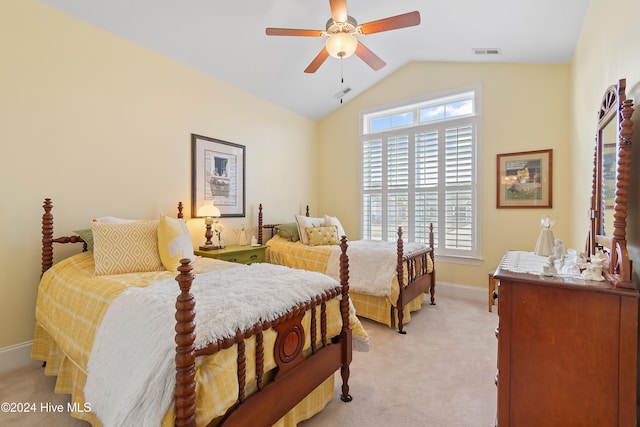 bedroom featuring ceiling fan, light colored carpet, and vaulted ceiling