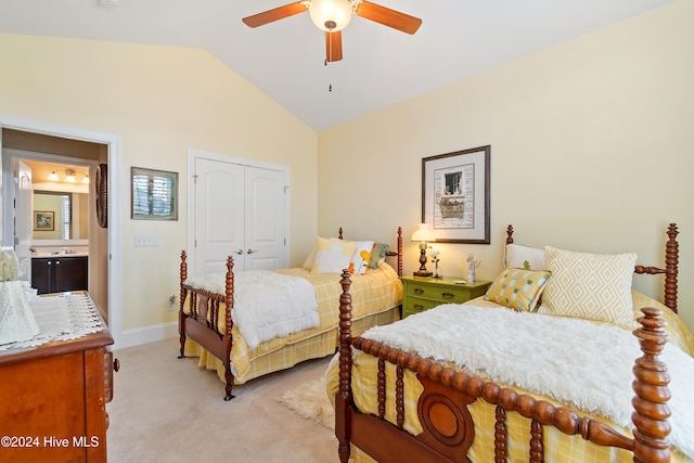 carpeted bedroom with ceiling fan, a closet, lofted ceiling, and sink