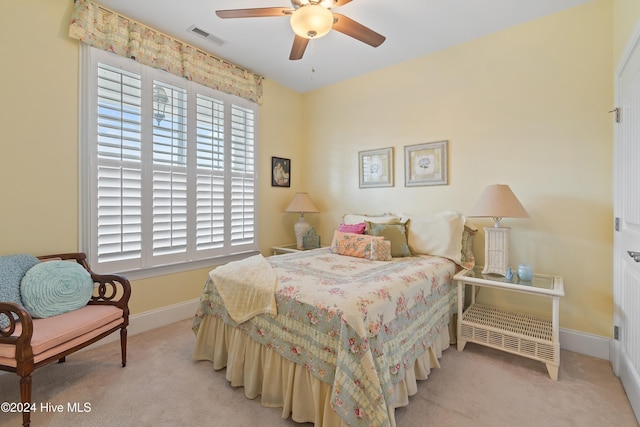 bedroom featuring light colored carpet and ceiling fan