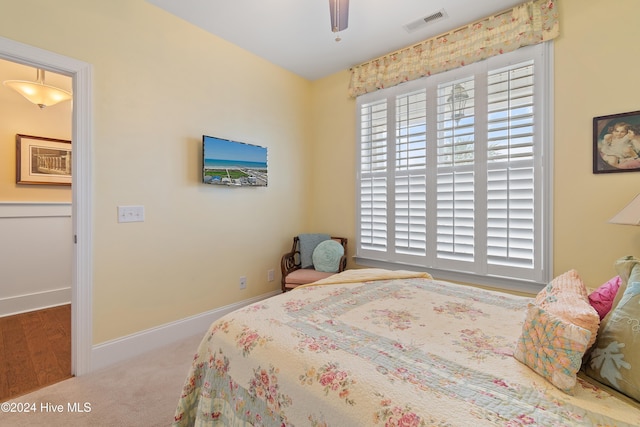 bedroom with carpet flooring, ceiling fan, and multiple windows