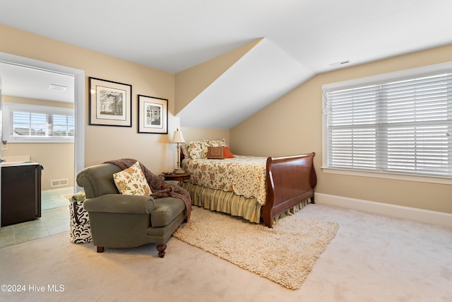 bedroom with light carpet and vaulted ceiling