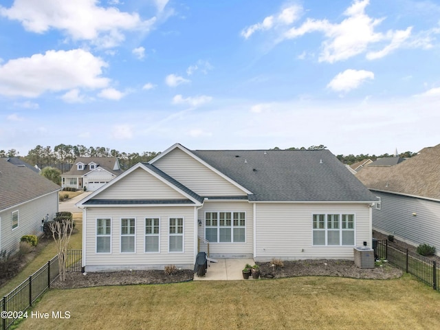 rear view of property with central air condition unit, a yard, and a patio