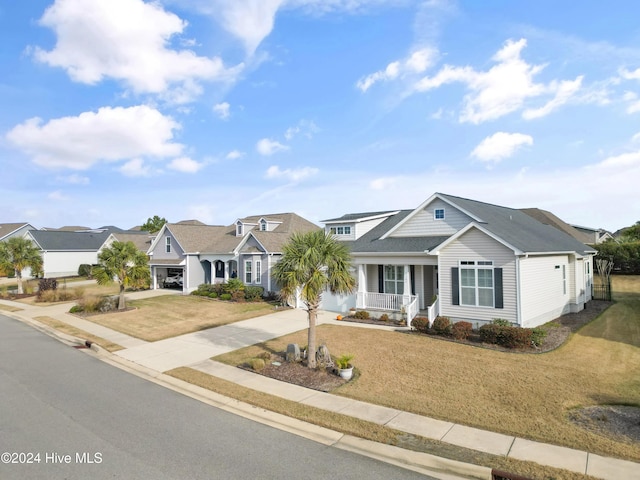 view of front of home with a front yard, a porch, and a garage