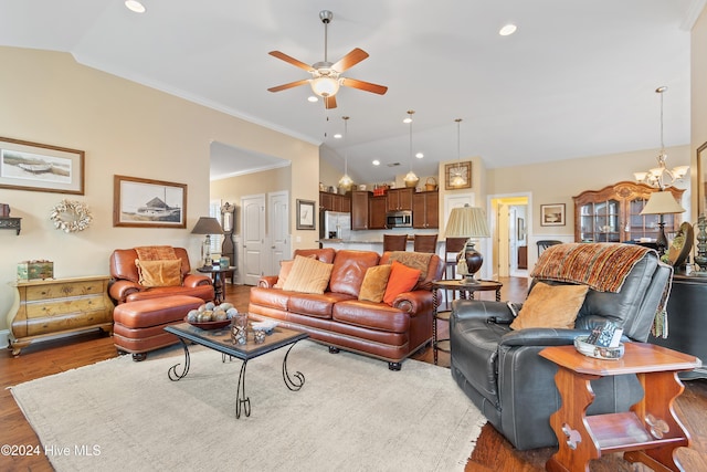 living room with ornamental molding, ceiling fan with notable chandelier, dark hardwood / wood-style floors, and lofted ceiling