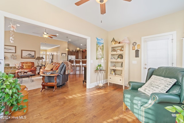 living area with ceiling fan and hardwood / wood-style floors