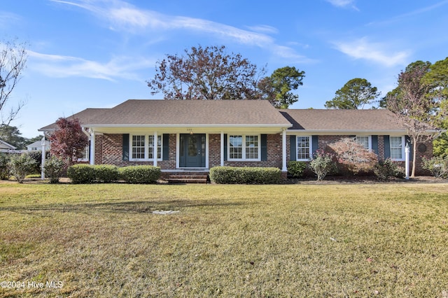 ranch-style house with covered porch and a front yard