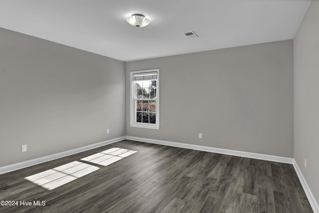 empty room featuring dark wood-type flooring