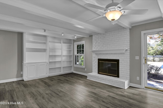 unfurnished living room with beamed ceiling, a fireplace, crown molding, and dark wood-type flooring