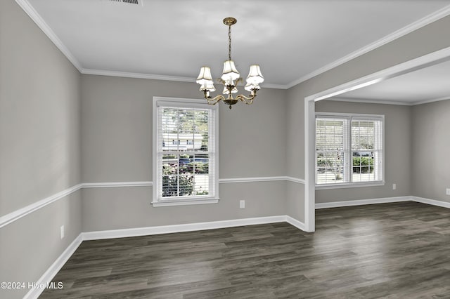 spare room featuring crown molding, dark hardwood / wood-style flooring, and an inviting chandelier