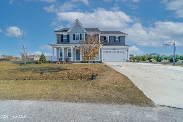 view of front of property featuring a front lawn, covered porch, and a garage