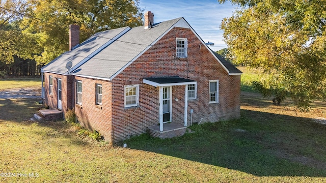 bungalow-style home with a front lawn